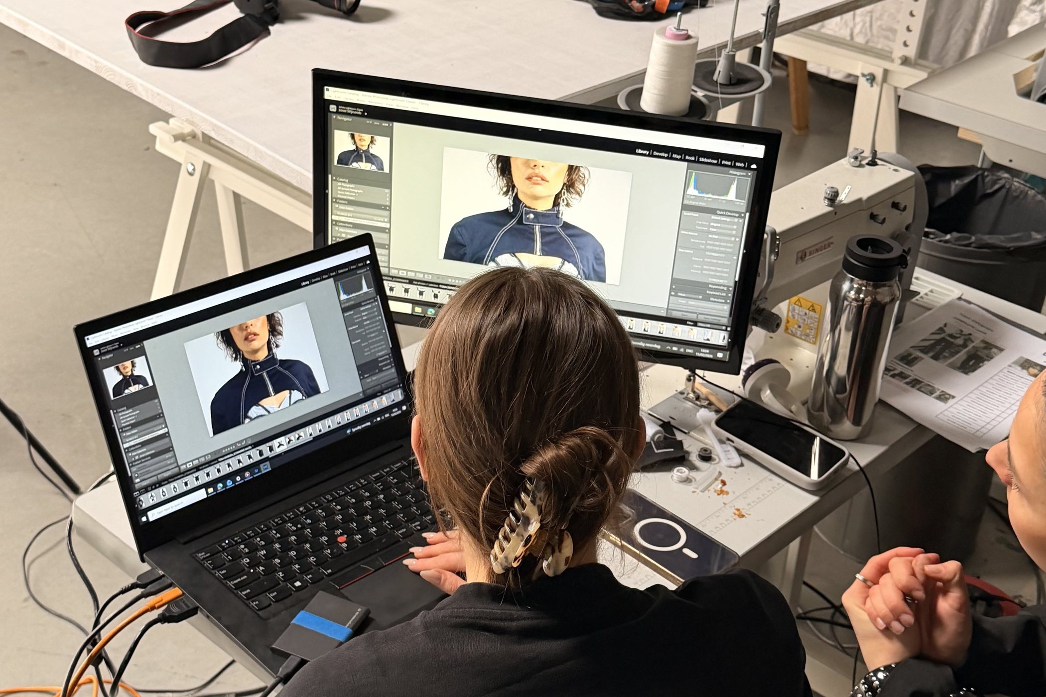 Editor reviewing a shoot on a laptop and a large monitor