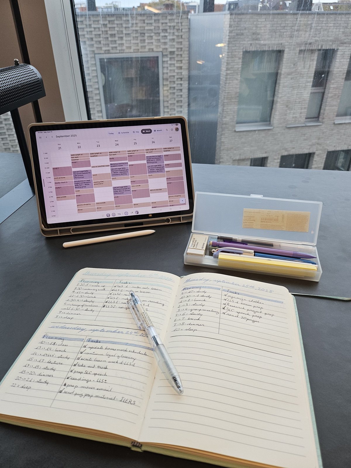 Planner and a tablet calendar open on a desk